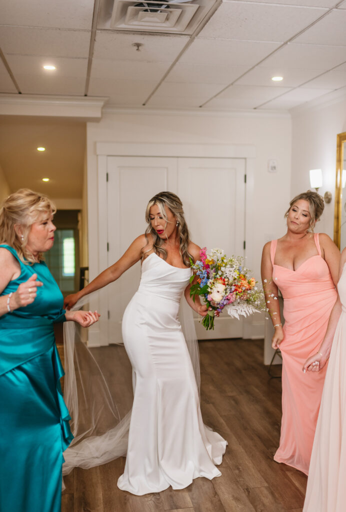 Renault Winery wedding in Egg Harbor, NJ. A bride in her getting ready suit at Renault Winery wedding venue dancing to music with her family and friends.