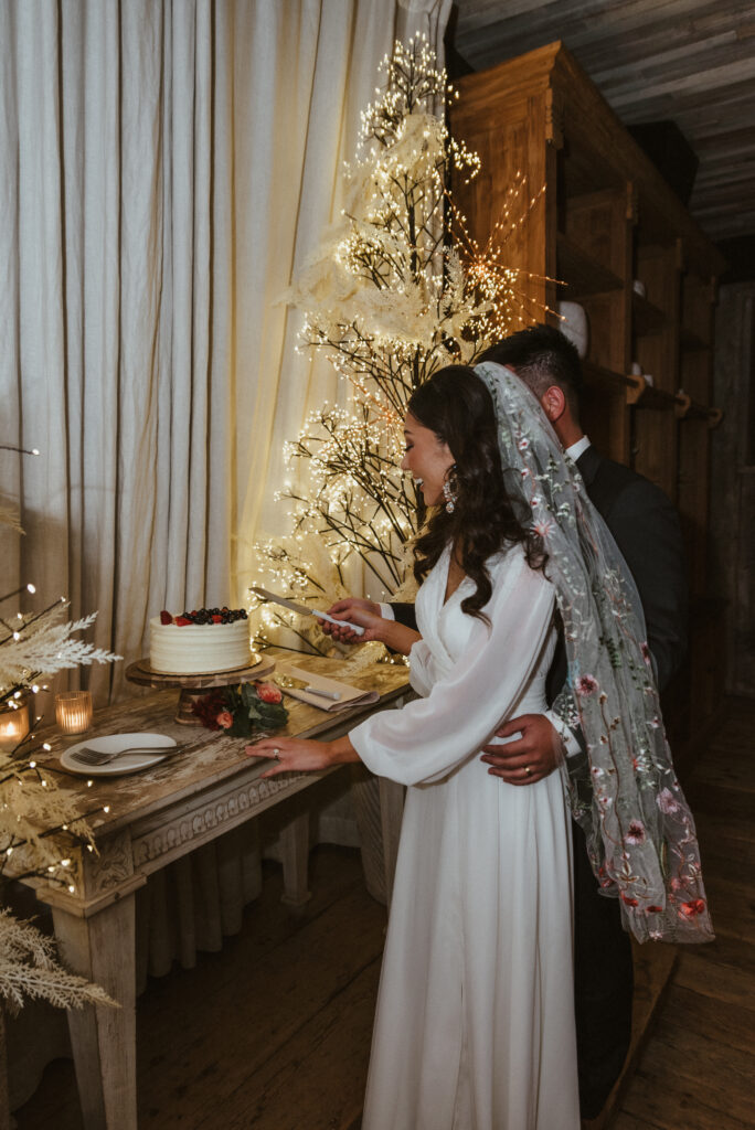 A bride and groom cutting their wedding cake at Terrain at Styers. 