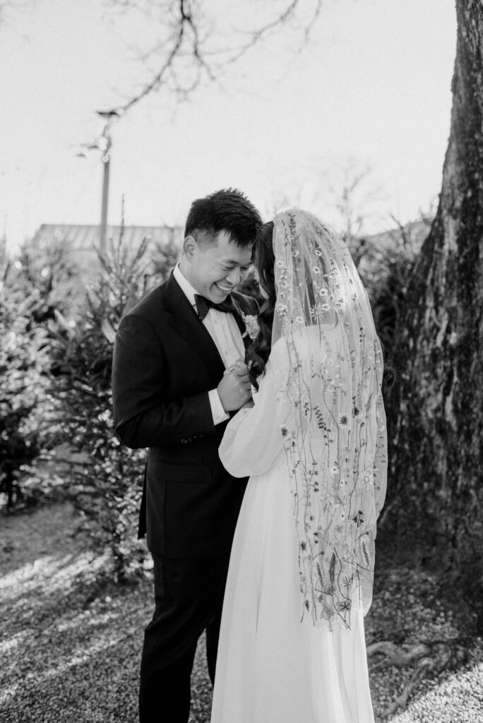 A bride and groom posing on their wedding day. Terrain at Styers.