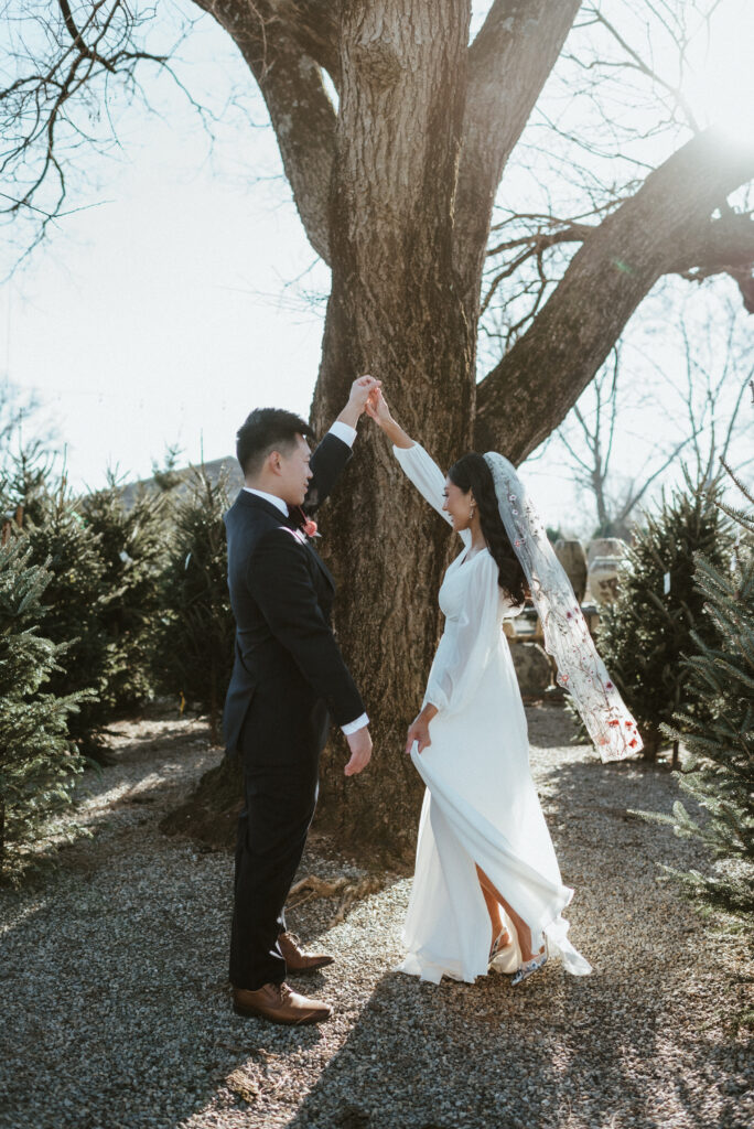 A groom spinning his bride on their wedding day. Terrain at Styers.