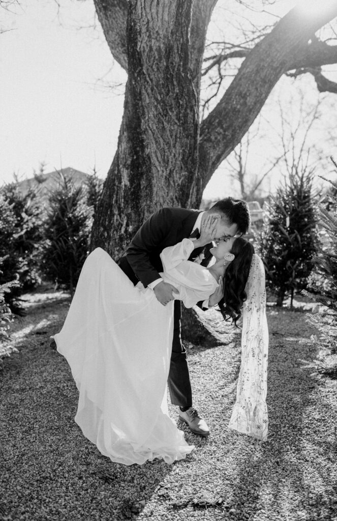 A groom dipping his bride on their wedding day. Terrain at Styers.