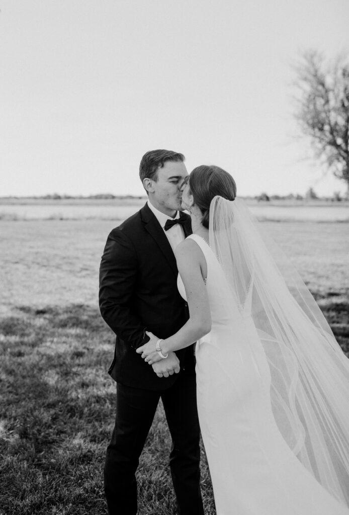 A bride and groom kissing on their wedding day.