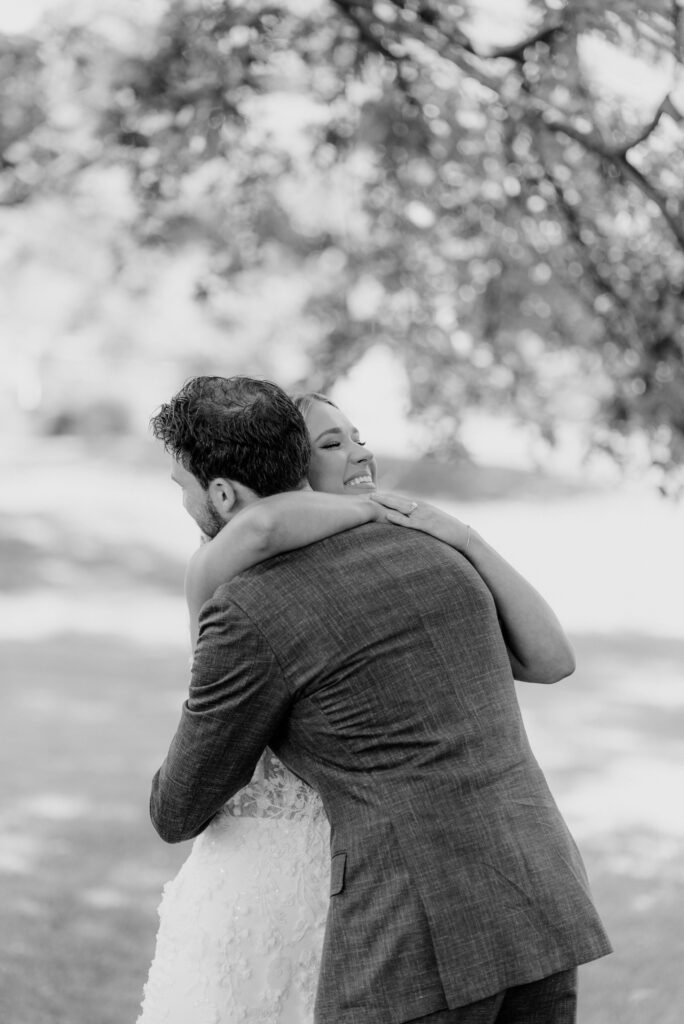 Bride and groom hugging after first look at Inn at Grace Winery in Glen Mills, PA
