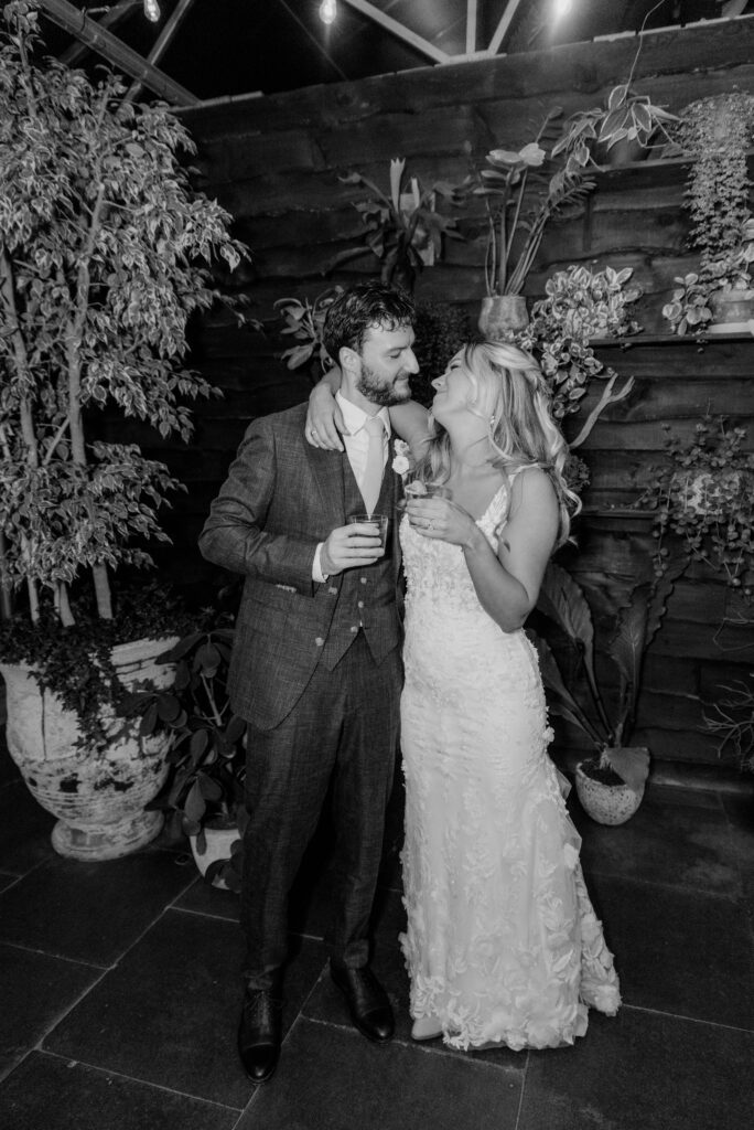 Bride and groom cheering drinks at Terrain Gardens at Styers in Glen Mills, PA!