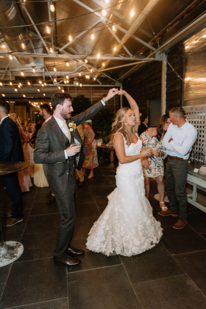 Groom spins his bride at their wedding reception at at Terrain Gardens at Styers in Glen Mills, PA!