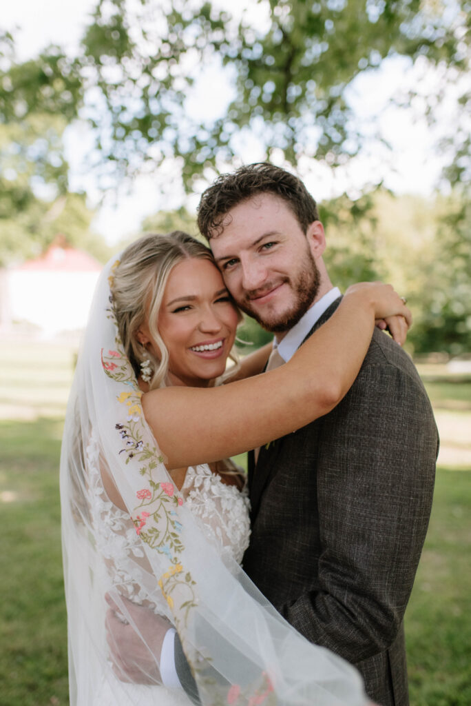 Wildflower veil for bride during her portraits with groom at the Inn at Grace Winery in Glen Mills, PA.