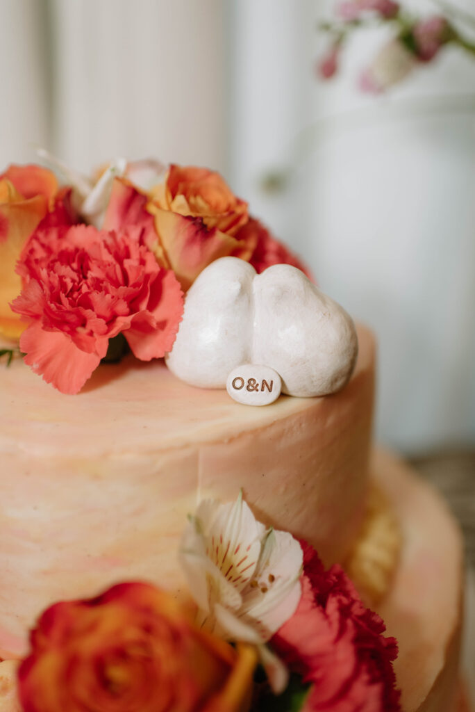 Cute love birds cake topper with inscribe monograms of the wedding couple at Terrain Gardens at Styers in Glen Mills, PA!